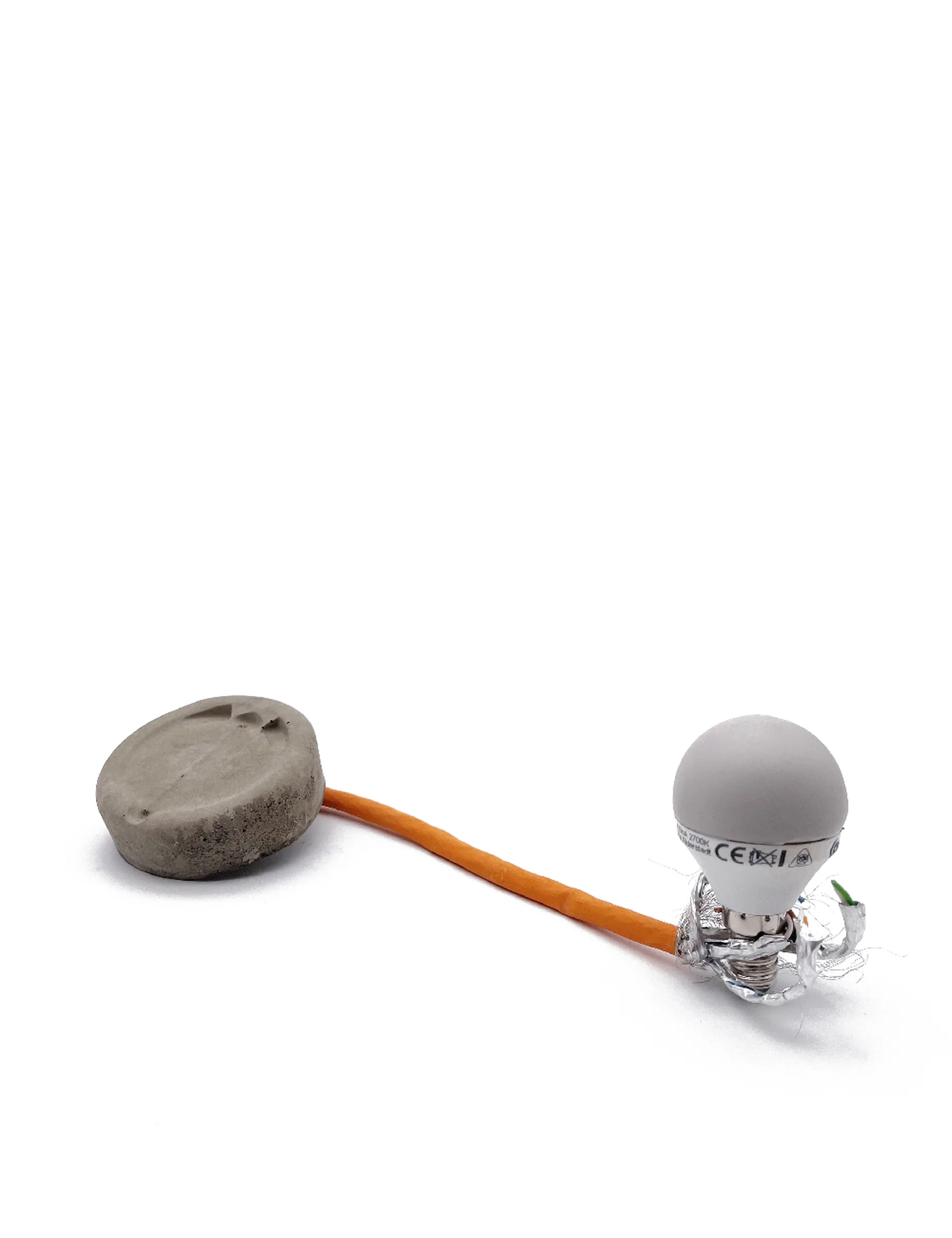 Item for the Great Reset: Safe Light Bulb, conceptual sculpture by Barbara K. Prokop using a light bulb, cable, concrete and acrylic paint