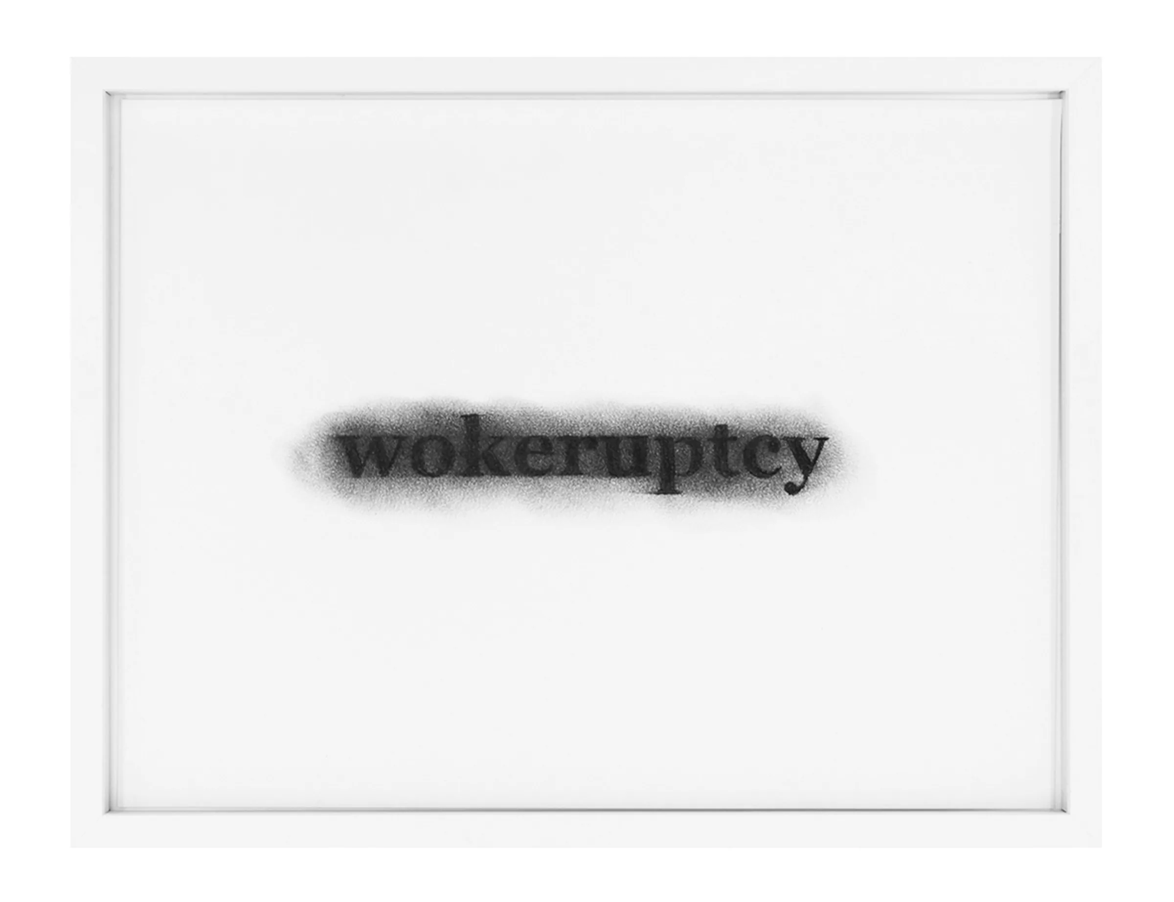 Framed white paper with the stenciled black word 'wokeruptcy' softened by a sprayed halo; Pastel on paper titled wokeruptcy by Barbara K. Prokop.